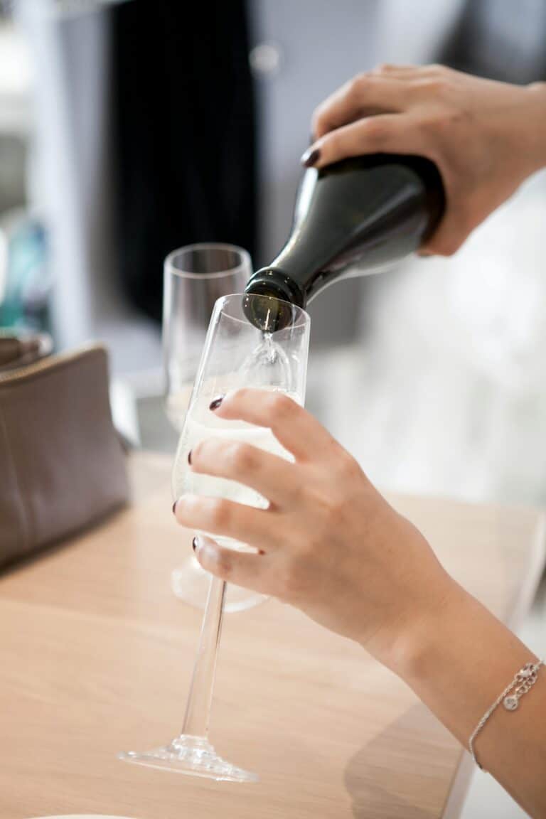 A close-up of champagne being elegantly poured into a glass flute. Perfect for celebrations.